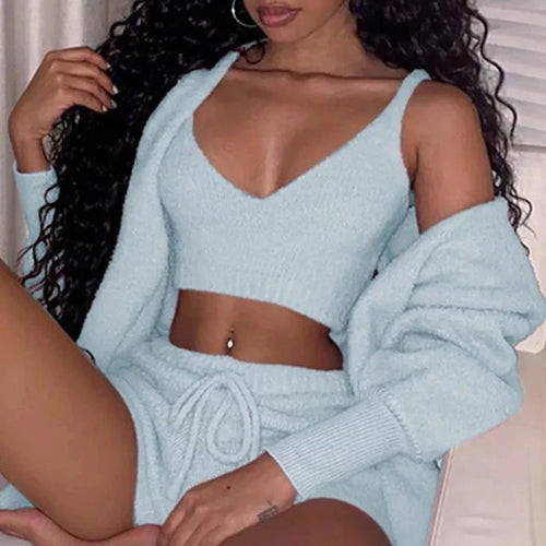 Woman wearing soft velvet pajama cami and shorts set