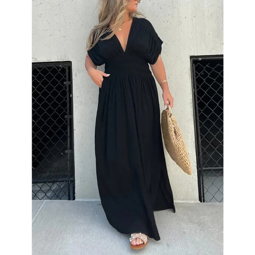 Woman wearing bat-sleeve maxi dress with slit
