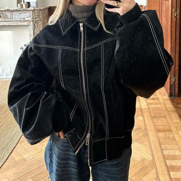 Women's moto vest layered over long sleeve top